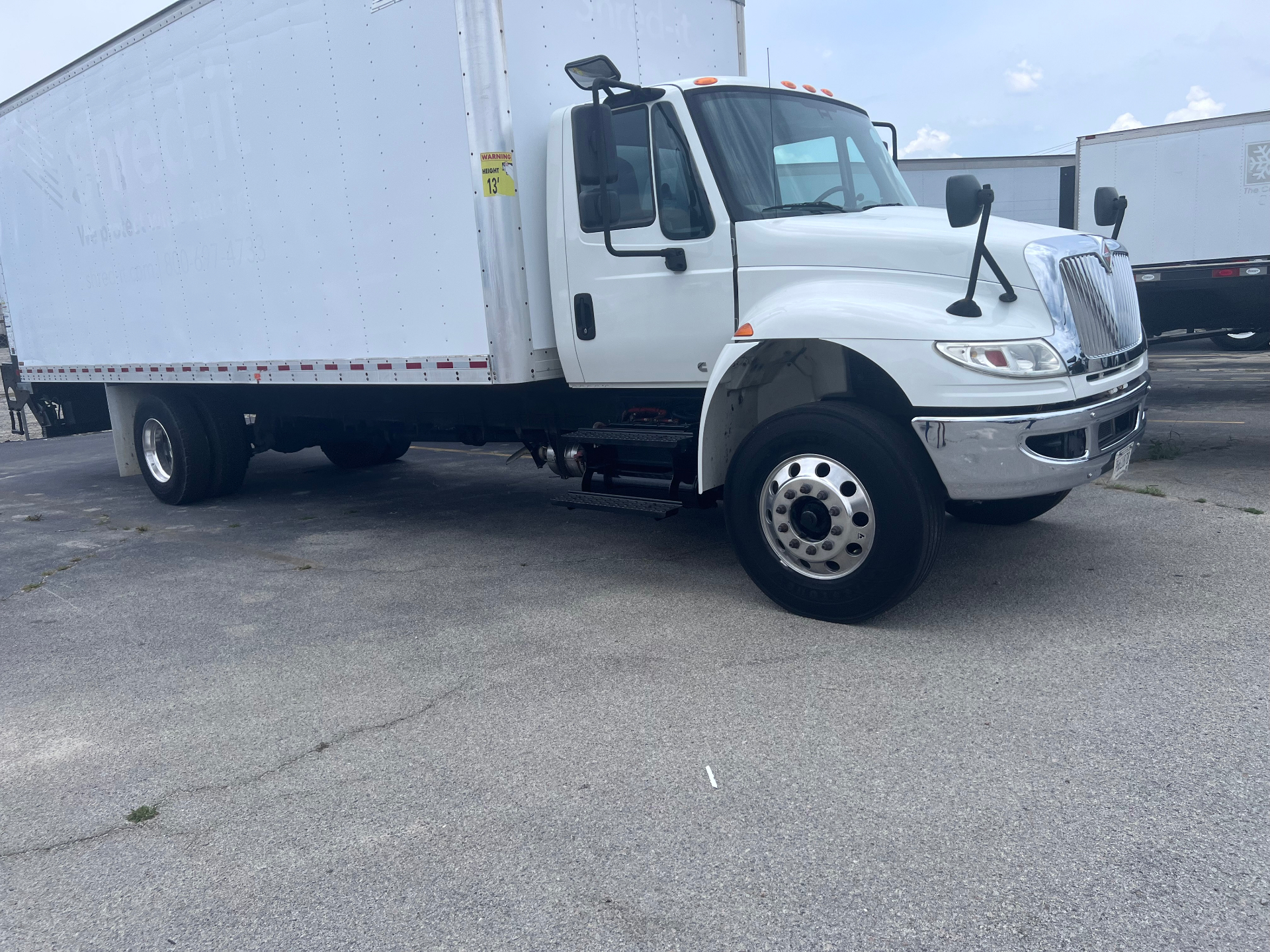 White 26-foot box truck at loading dock